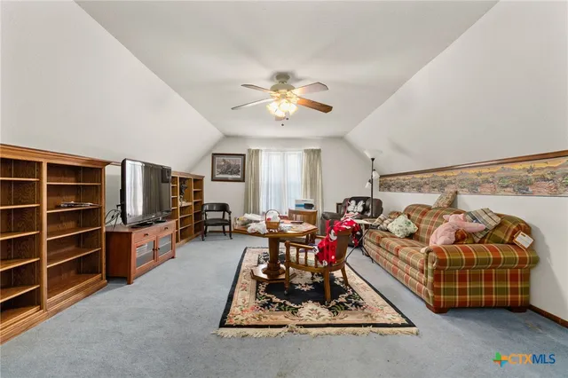 a living room with furniture gym equipment and a flat screen tv