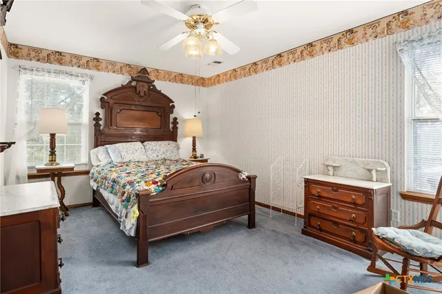 a bedroom with a bed and a chandelier