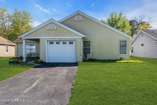 a front view of house with yard and green space