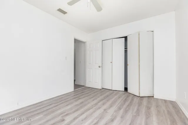 a view of a room with wooden floor