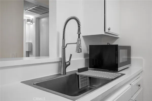 a kitchen with a sink and a microwave
