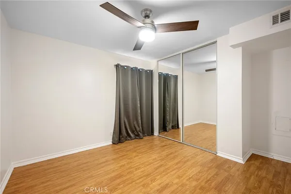 a view of a room with a ceiling fan