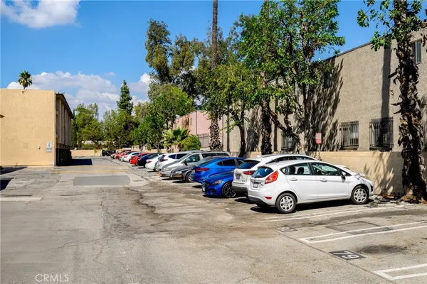 a view of cars parked on the side of a street