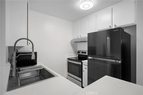 a kitchen with a refrigerator and cabinets