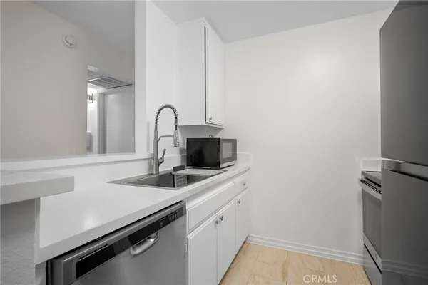 a kitchen with a sink and a refrigerator