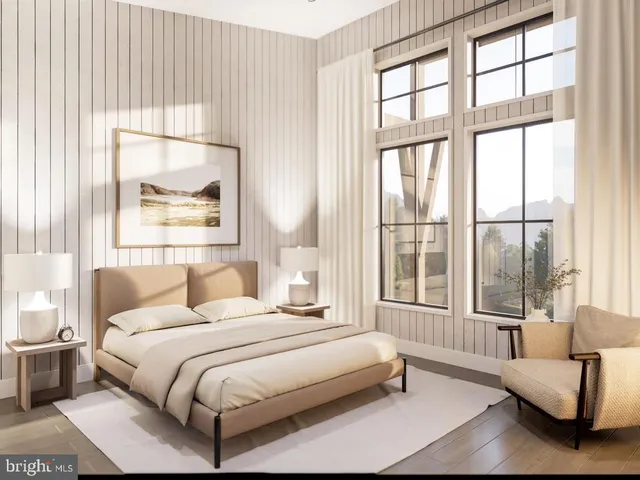 a bedroom with a bed and a large window