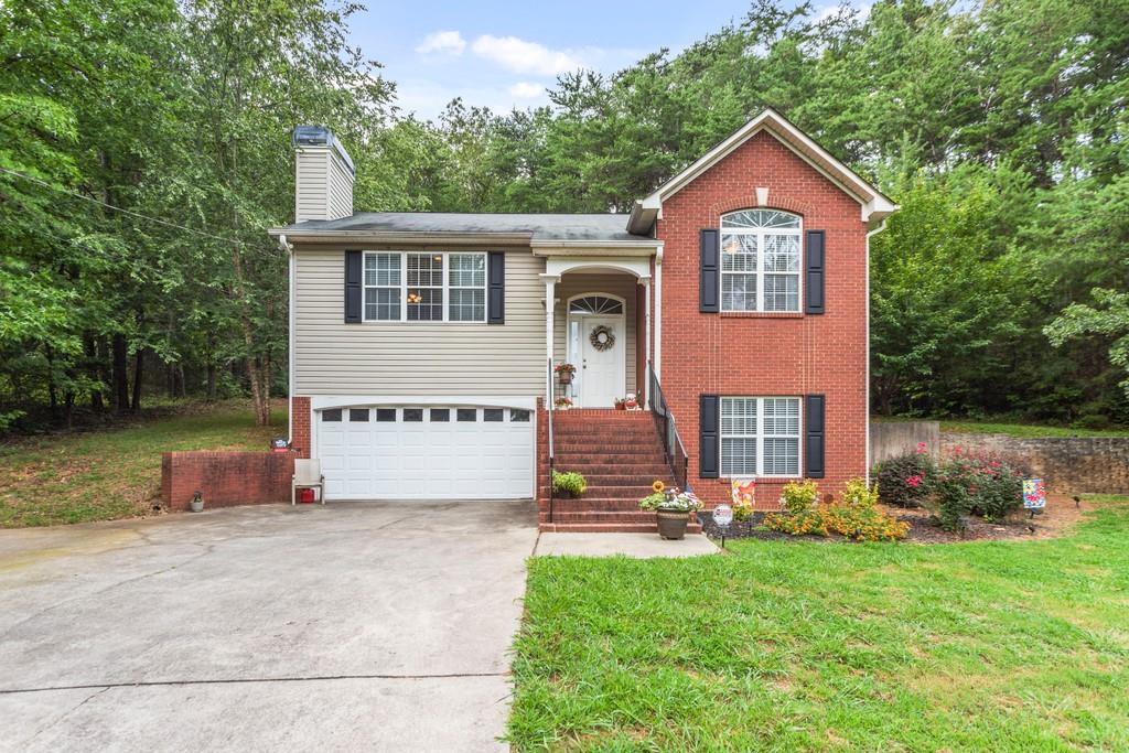 a front view of house with yard and green space