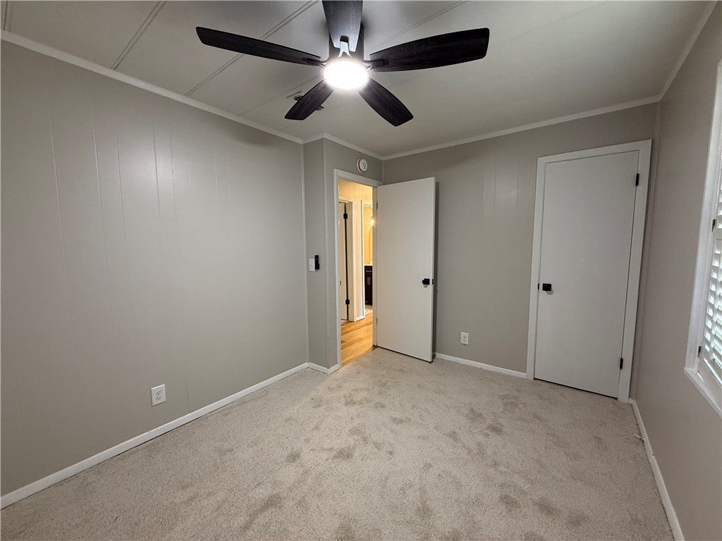 306 Crawford Road Opelika, AL 36804 - Photo 14 of 31 This inviting bedroom offers comfort and style, perfect for peaceful relaxation and personal touches.