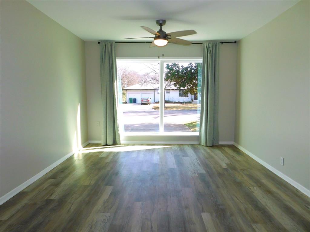 819 Thomas Street Denton, TX 76201 - Photo 11 of 33 an empty room with wooden floor and windows