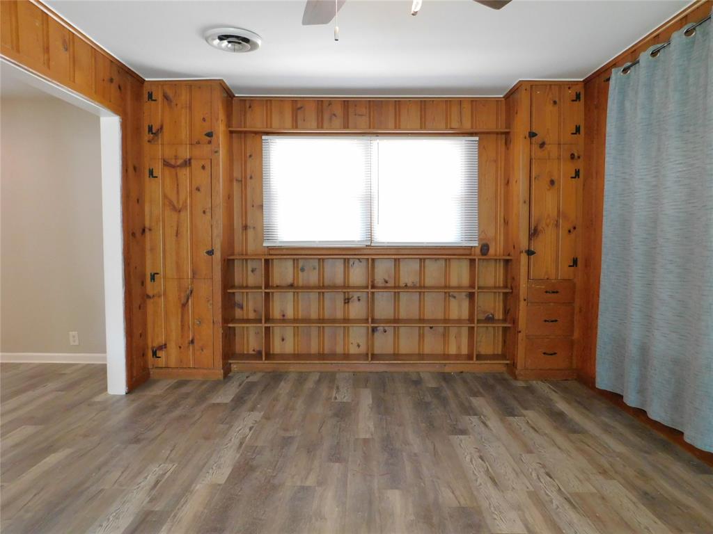 819 Thomas Street Denton, TX 76201 - Photo 12 of 33 a view of an empty room with wooden floor and a window