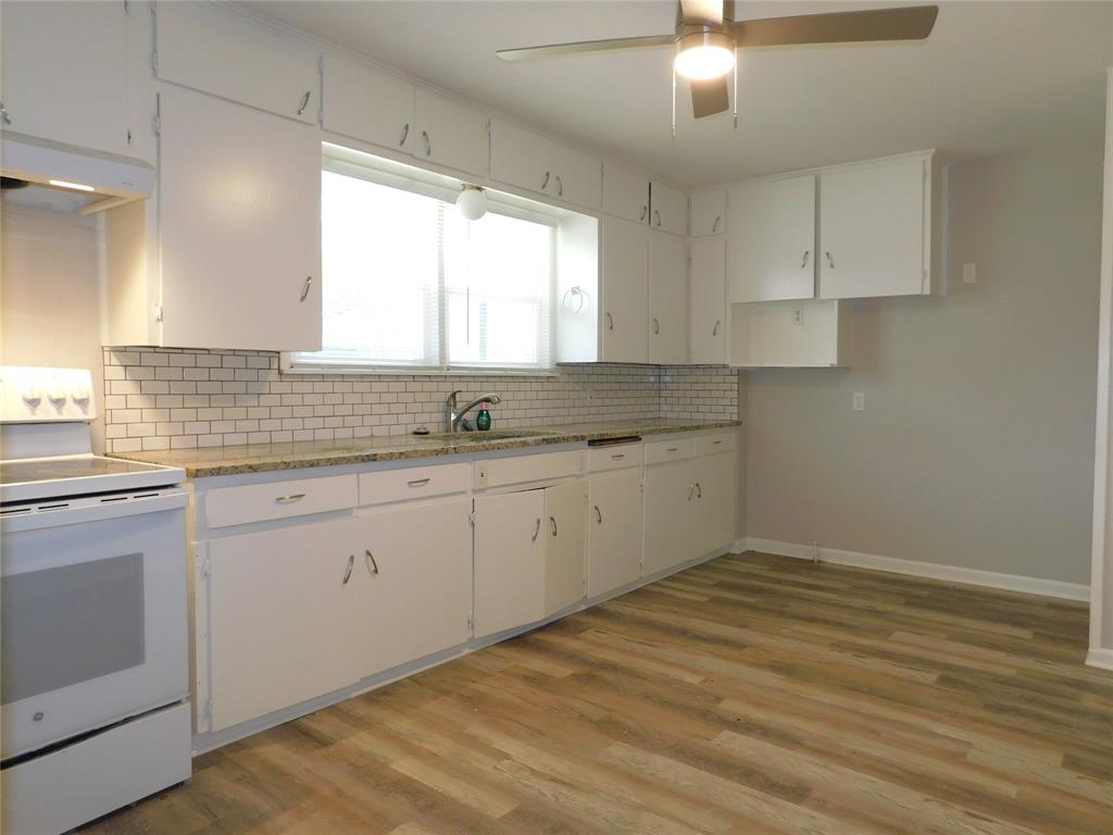 819 Thomas Street Denton, TX 76201 - Photo 14 of 33 a kitchen with a sink cabinets appliances and a window