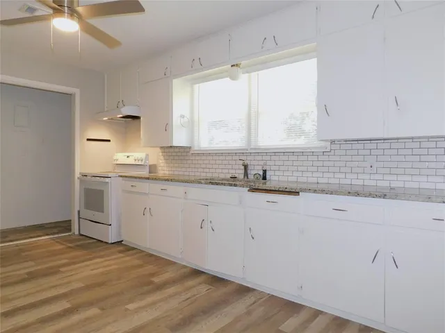 a kitchen with a sink cabinets and window