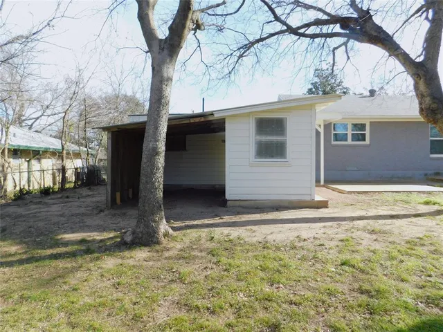 a view of a field with trees