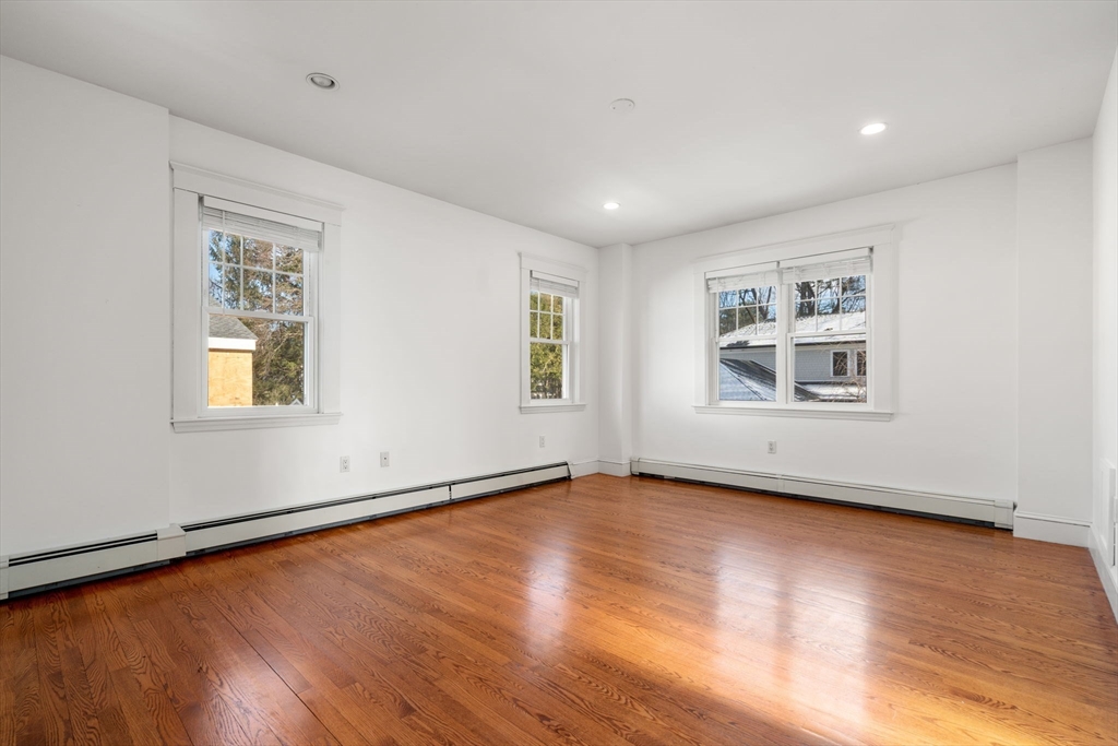 16 Intervale Road Wellesley, MA 02481 - Photo 14 of 24 a view of an empty room with wooden floor and a window