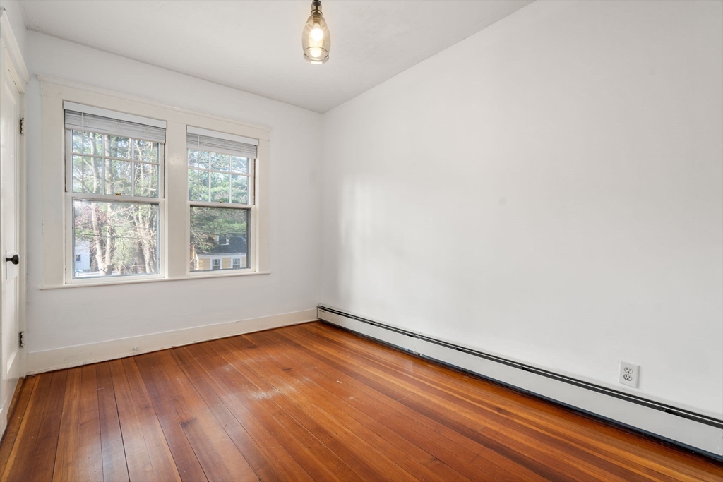 16 Intervale Road Wellesley, MA 02481 - Photo 19 of 24 an empty room with wooden floor and windows