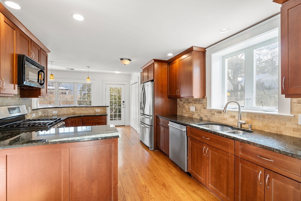 16 Intervale Road Wellesley, MA 02481 - Photo 7 of 24 a kitchen with stainless steel appliances granite countertop a sink stove and refrigerator
