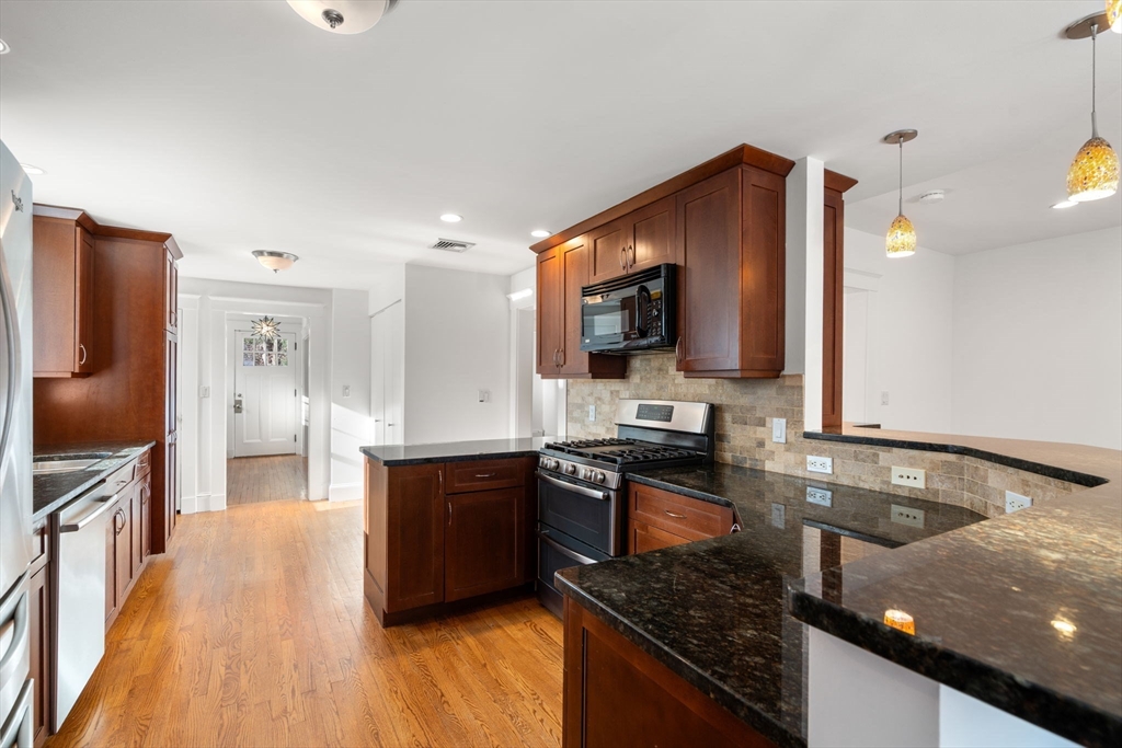 16 Intervale Road Wellesley, MA 02481 - Photo 8 of 24 a kitchen with stainless steel appliances granite countertop a sink stove and refrigerator