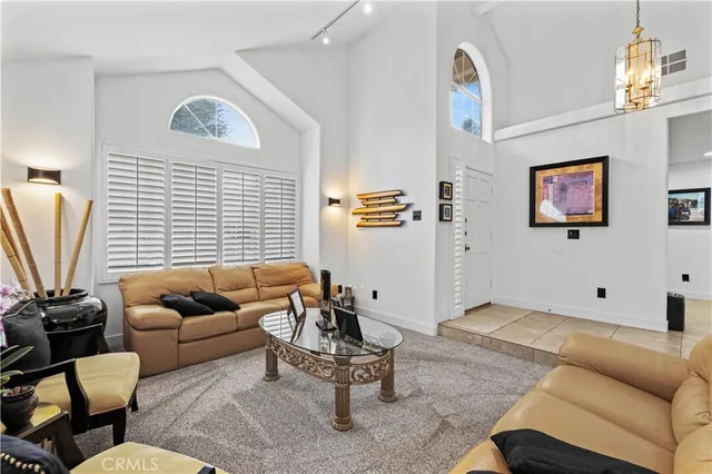 a living room with furniture a couch and a window