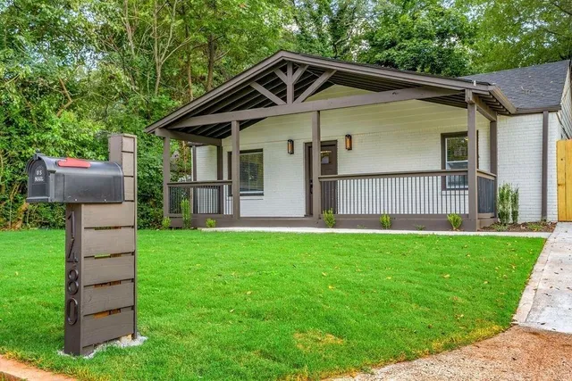 a front view of a house with a garden and yard