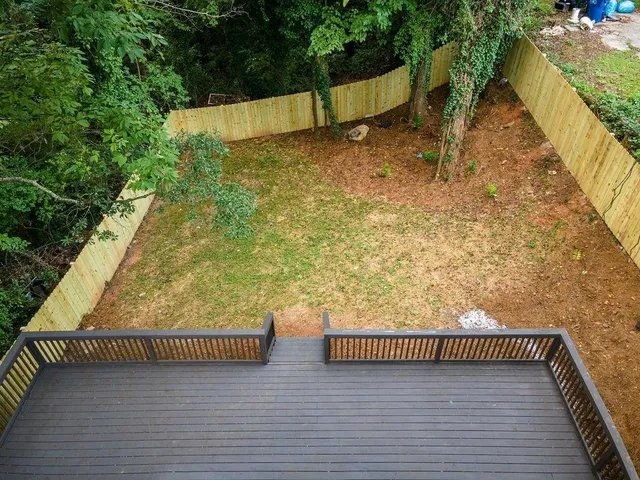 a view of balcony with wooden floor and fence