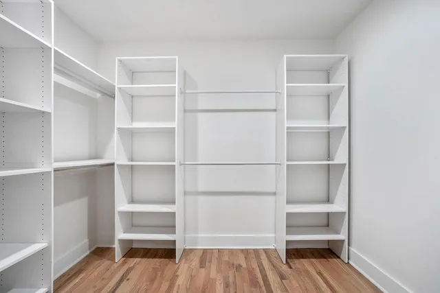 a view of walk in closet with empty racks