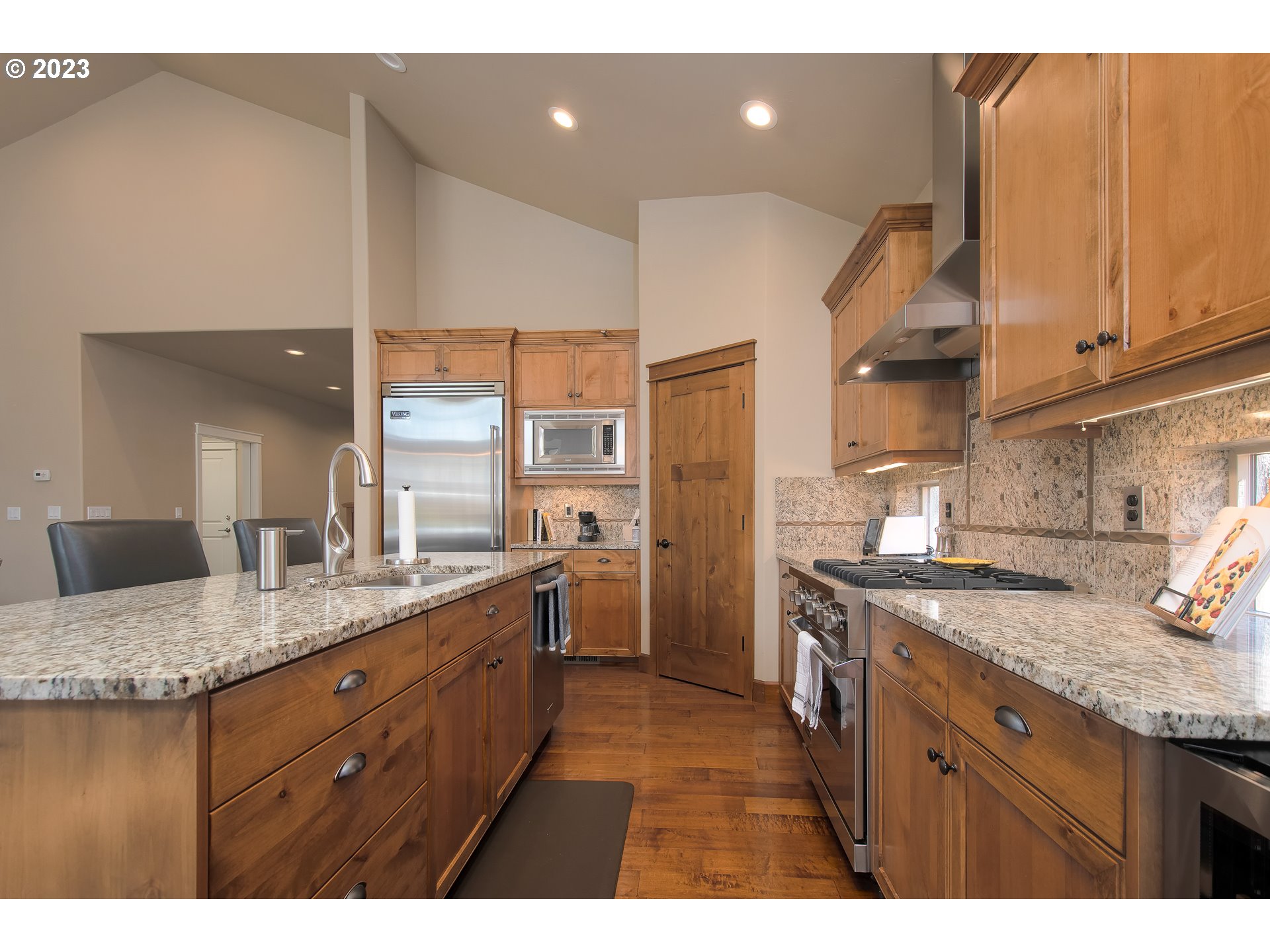 12918 Southwest Sevilla Avenue Portland, OR 97223 - Photo 15 of 44 a kitchen with stainless steel appliances granite countertop a sink a stove and a refrigerator