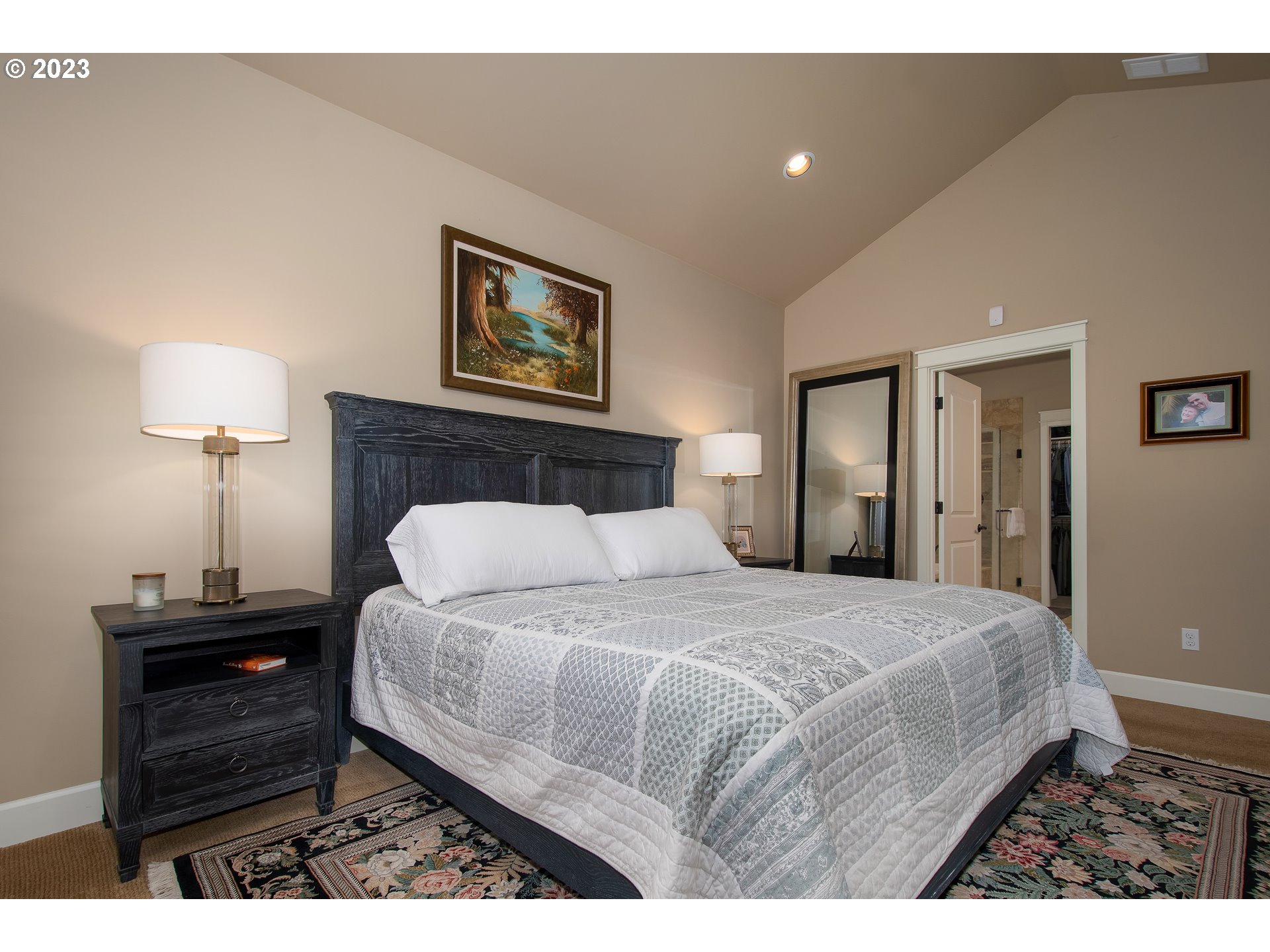 12918 Southwest Sevilla Avenue Portland, OR 97223 - Photo 22 of 44 a bedroom with a bed and a lamp on table