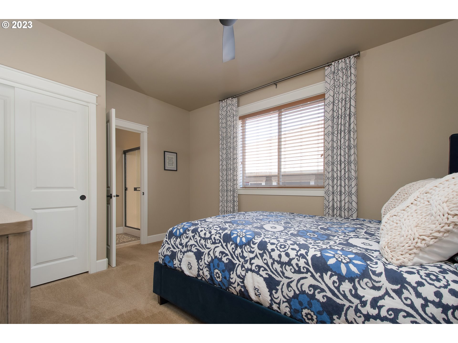 12918 Southwest Sevilla Avenue Portland, OR 97223 - Photo 25 of 44 a bedroom with a large bed and a window