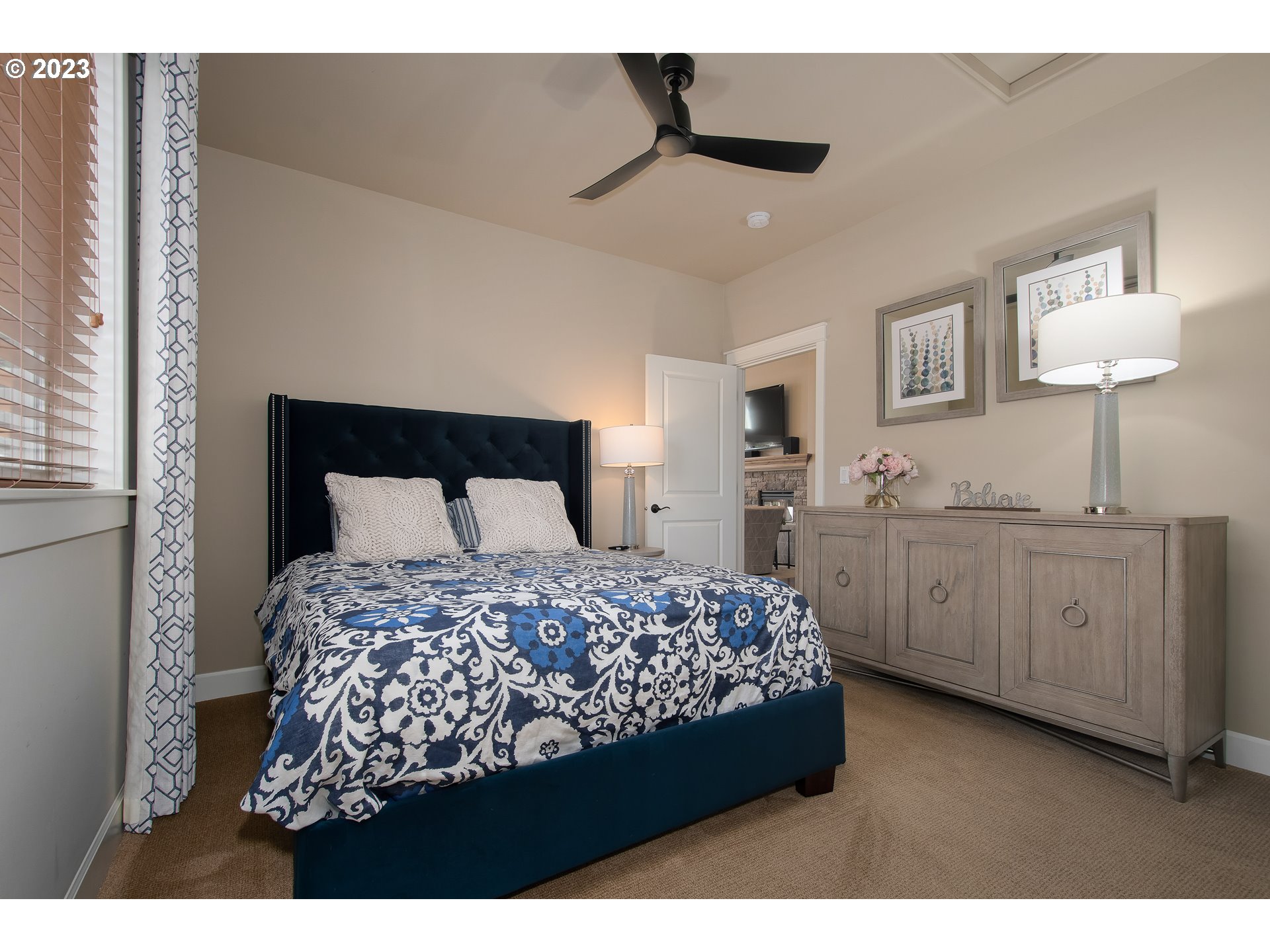 12918 Southwest Sevilla Avenue Portland, OR 97223 - Photo 26 of 44 a bedroom with a bed and a chandelier