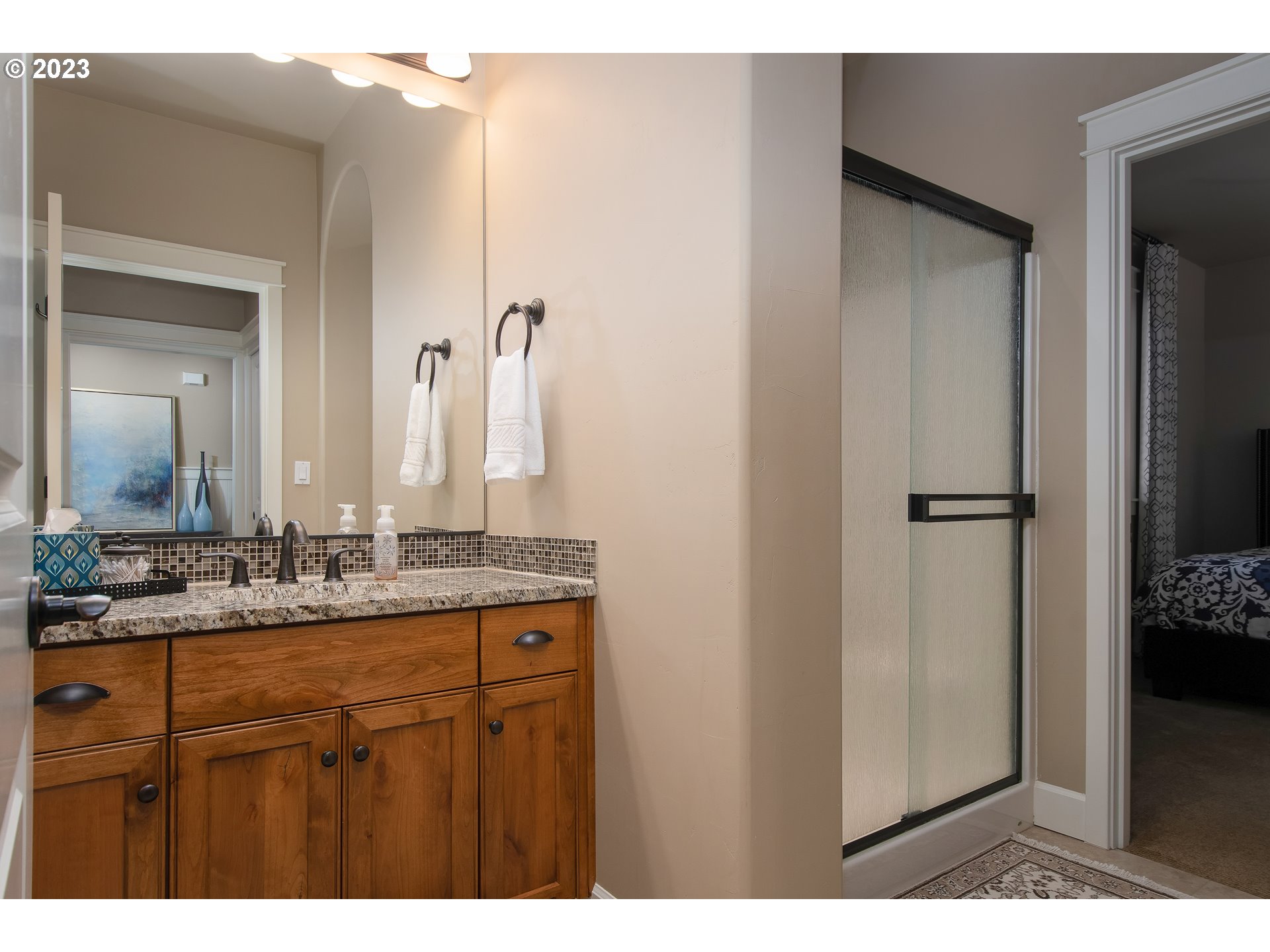 12918 Southwest Sevilla Avenue Portland, OR 97223 - Photo 27 of 44 a bathroom with a granite countertop sink and a mirror