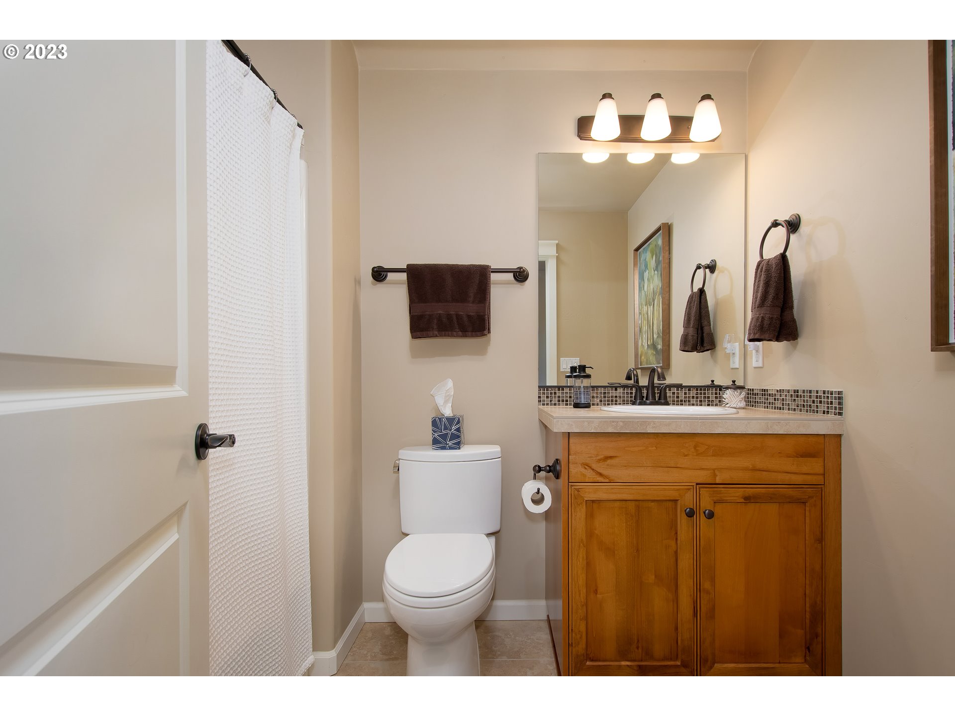 12918 Southwest Sevilla Avenue Portland, OR 97223 - Photo 32 of 44 a bathroom with a toilet sink and mirror