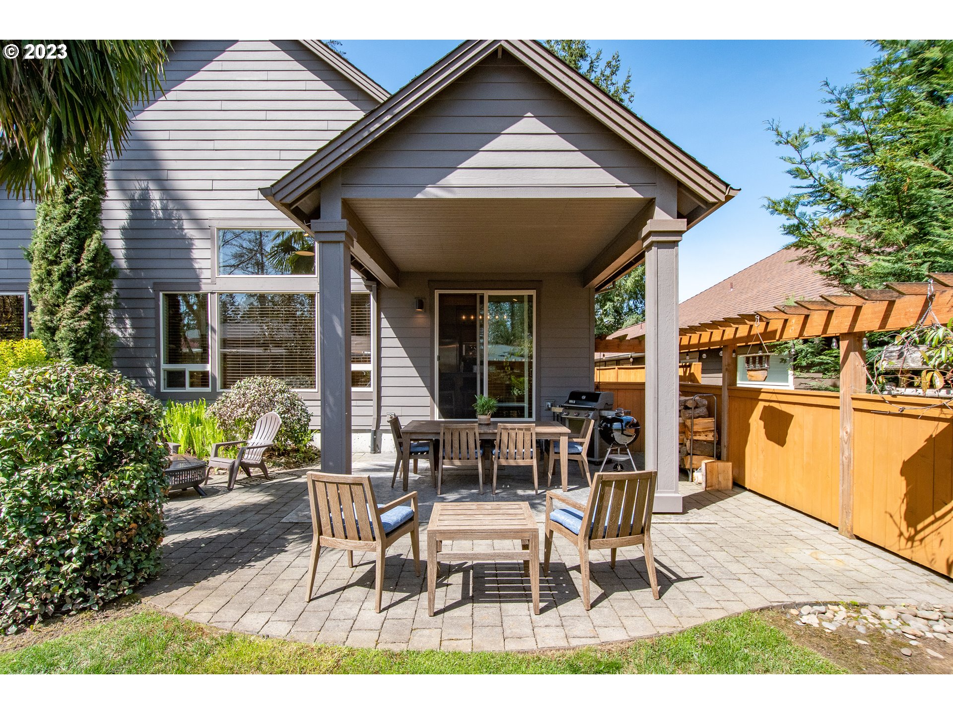 12918 Southwest Sevilla Avenue Portland, OR 97223 - Photo 36 of 44 a view of a patio with table and chairs with wooden floor and plants