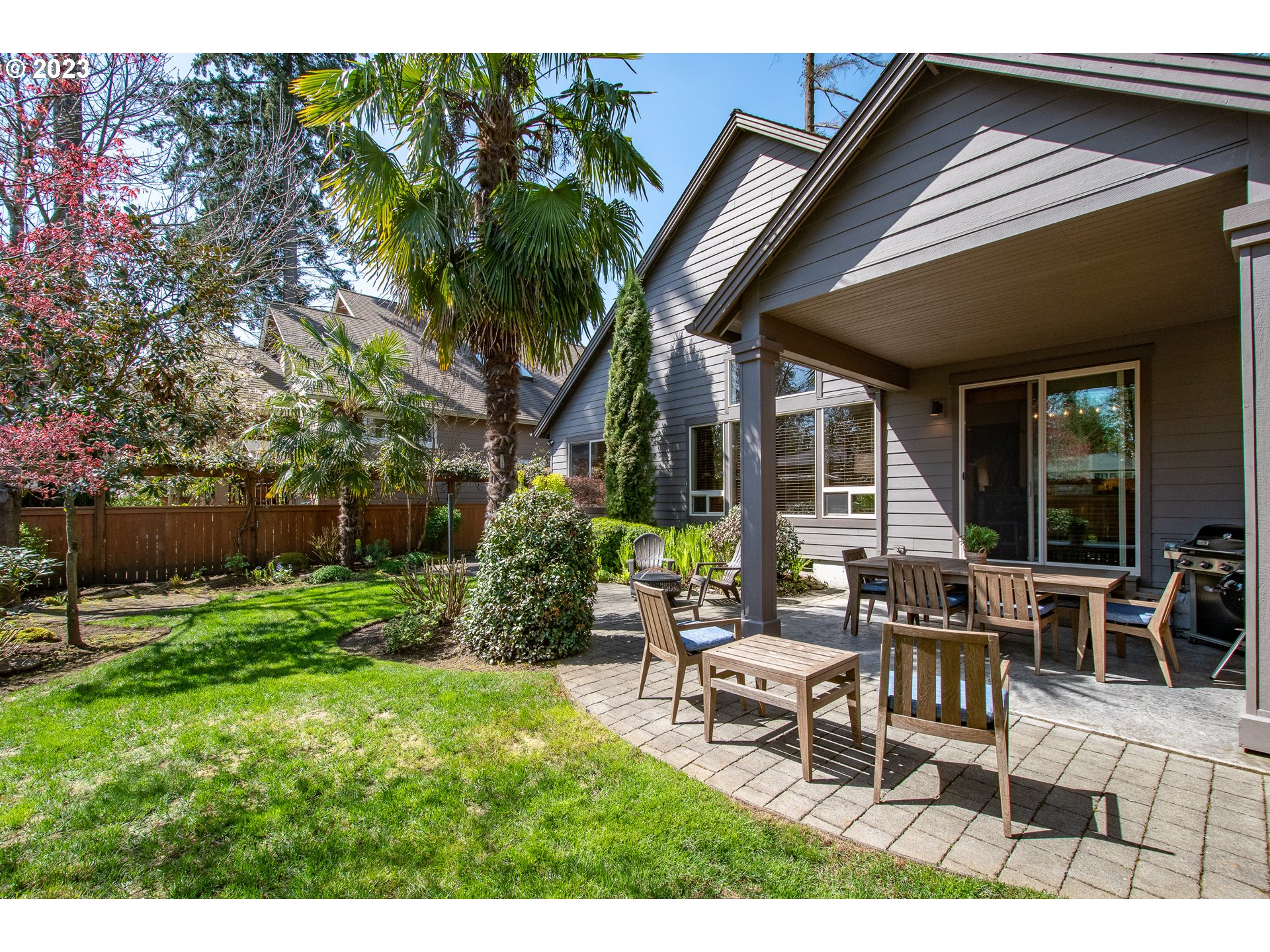 12918 Southwest Sevilla Avenue Portland, OR 97223 - Photo 37 of 44 a backyard of a house with table and chairs