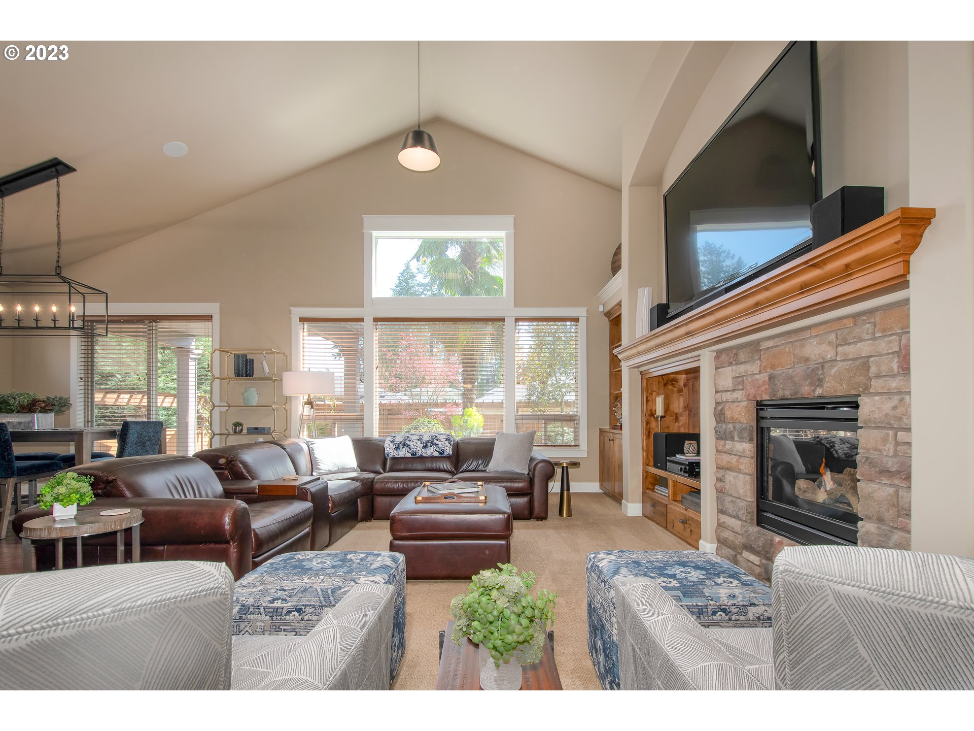 12918 Southwest Sevilla Avenue Portland, OR 97223 - Photo 6 of 44 a living room with furniture a flat screen tv and a fireplace