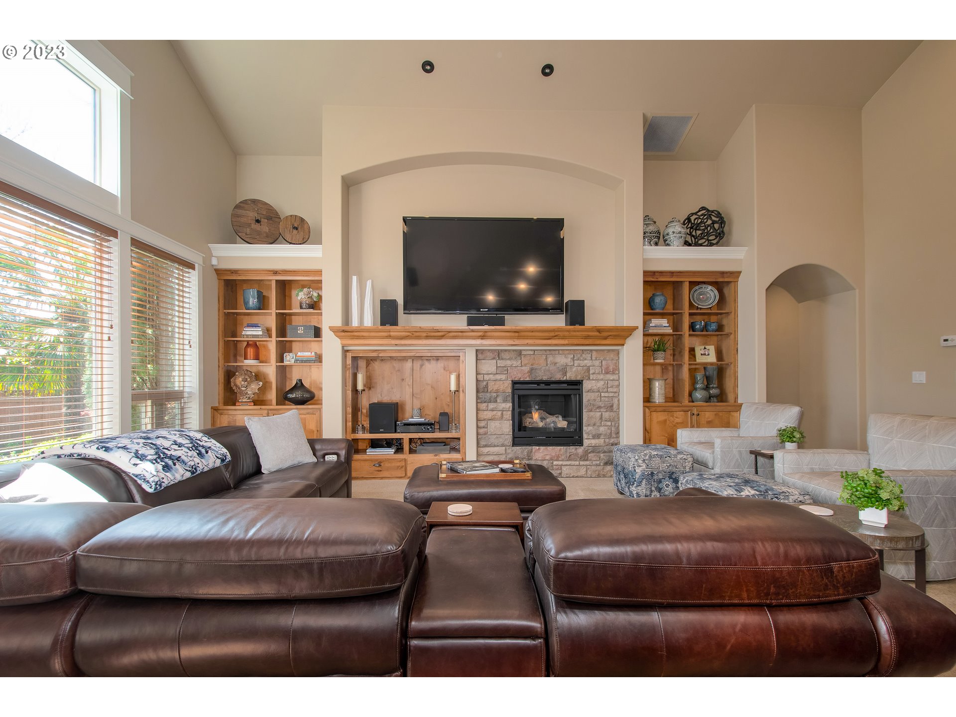 12918 Southwest Sevilla Avenue Portland, OR 97223 - Photo 9 of 44 a living room with furniture a fireplace and a flat screen tv