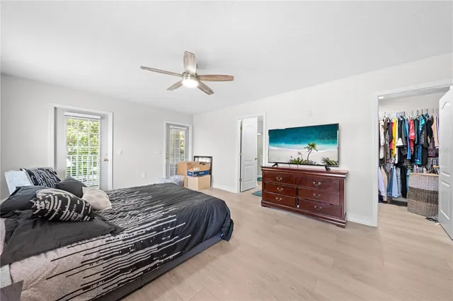 a living room with large windows and wooden floor