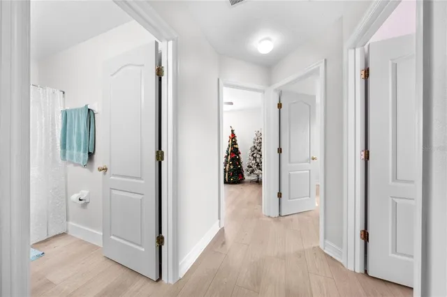 a living room with furniture a large window and wooden floor