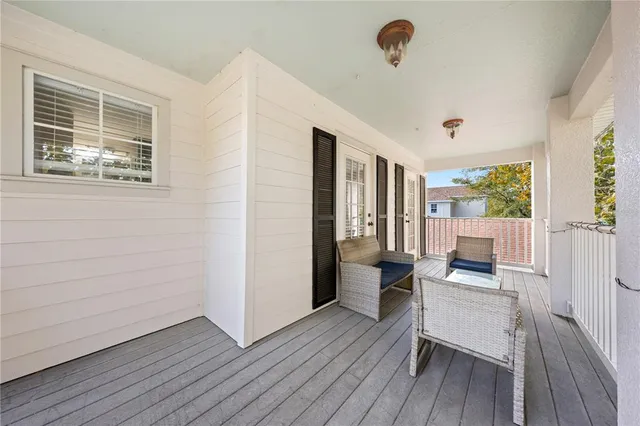 a front view of a house with porch and furniture