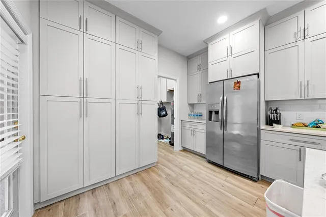 a bathroom with a double vanity sink and mirror with shower