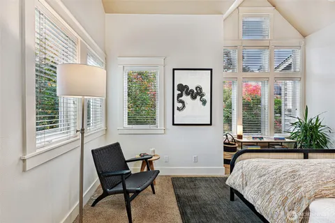 a bedroom with a bed and glass window