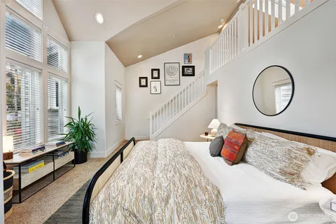 a bed room with a bed and a potted plant