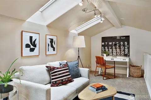 a bedroom with furniture and a rug