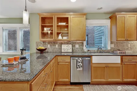 a kitchen with stainless steel appliances granite countertop a stove and a sink