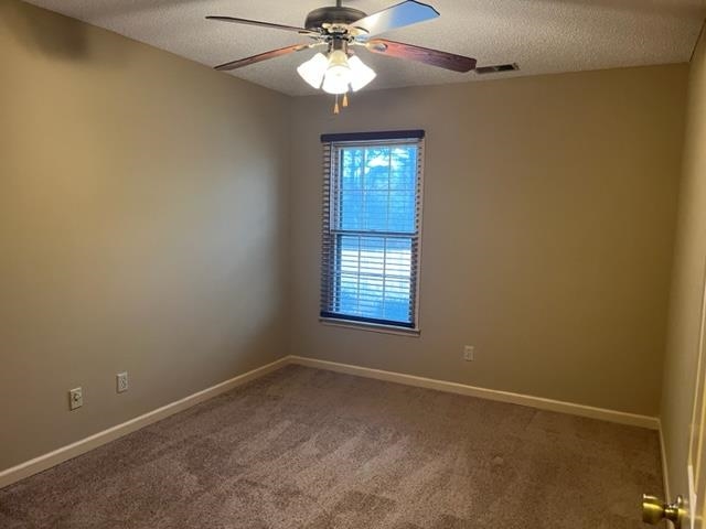5949 Blakeview Place Bartlett, TN 38134 - Photo 13 of 15 en empty room with windows and chandelier fan