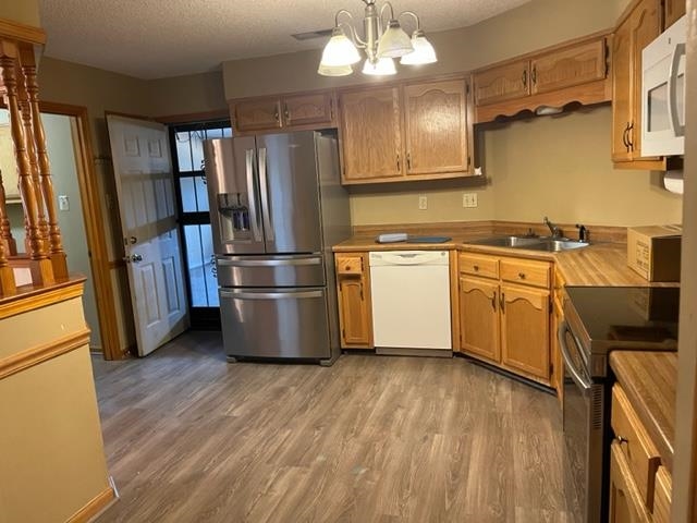 5949 Blakeview Place Bartlett, TN 38134 - Photo 7 of 15 a kitchen with stainless steel appliances granite countertop a refrigerator a sink dishwasher a stove and a refrigerator with wooden floor