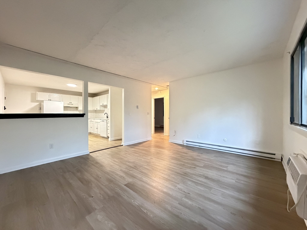 18 Pierce Street, Unit 3B Foxboro, MA 02035 - Photo 6 of 21 an empty room with wooden floor and windows