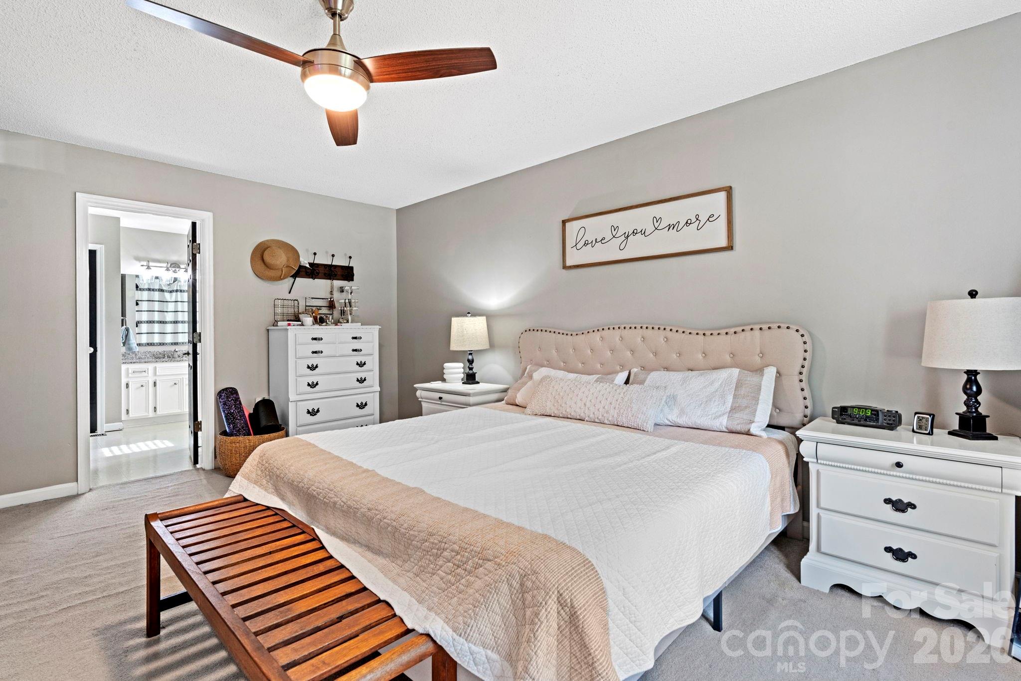 5750 Ellenwood Road Granite Falls, NC 28630 - Photo 12 of 38 a bedroom with a bed and a chandelier
