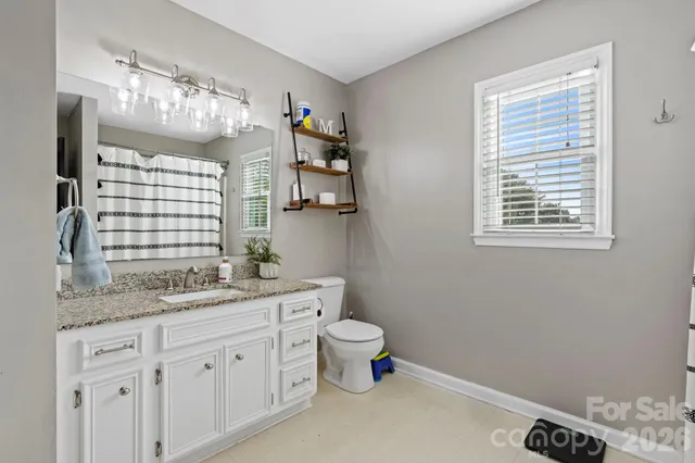 a view of walk in closet with clothes