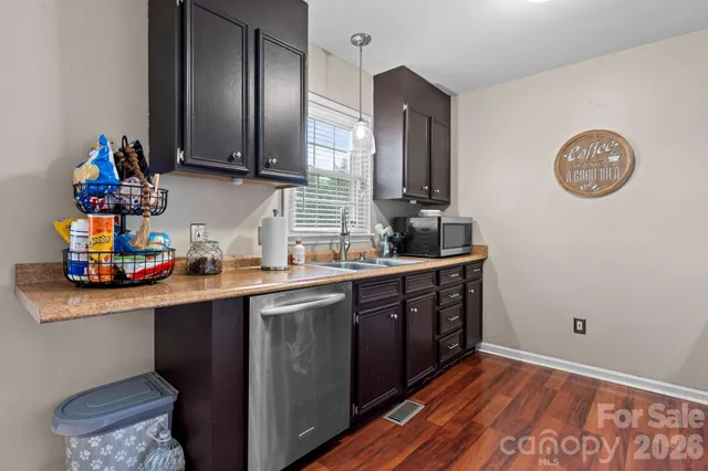 a kitchen with stainless steel appliances granite countertop a stove and a microwave