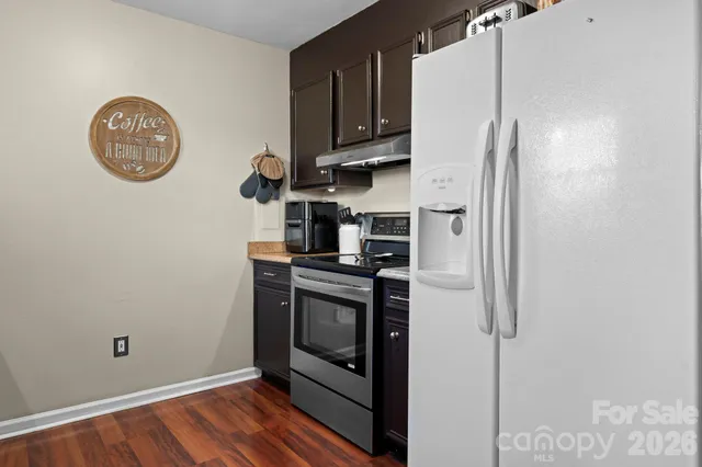 a utility room with dryer washer and a view of living room